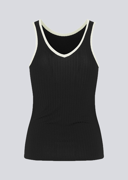 Tight-fitted black sleeveless top in a stretchy material with a round neck cutting lower on the back. FaizMD top has contrasting bias tape. 