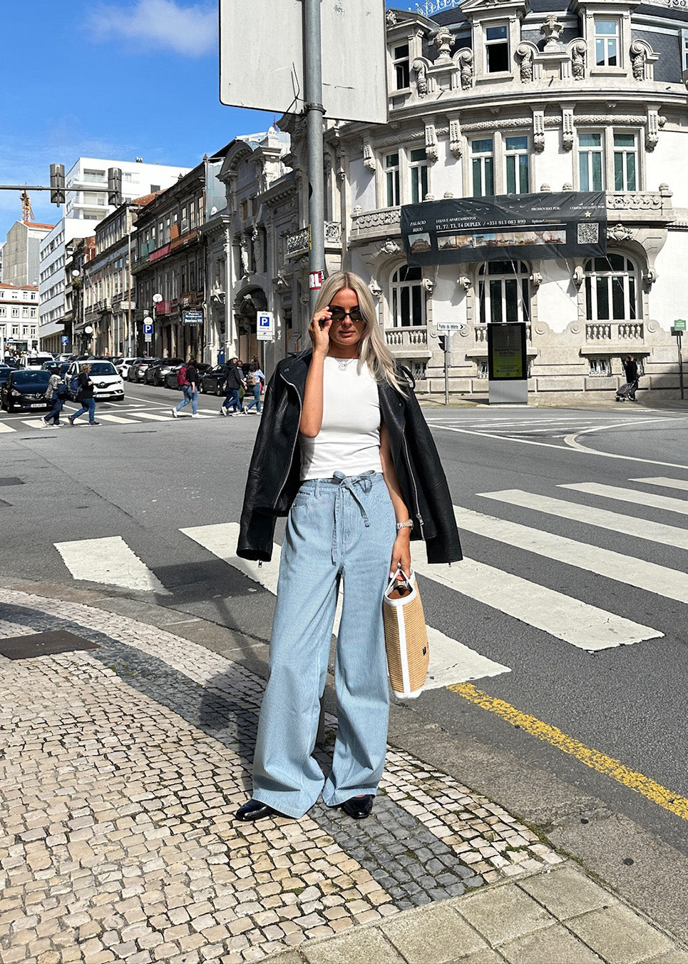 Jeans with wide legs in cotton denim in soft blue with white stripes. IsoldeMD pants have a high waist, front and back pockets, and a tie band at the waist.&nbsp;