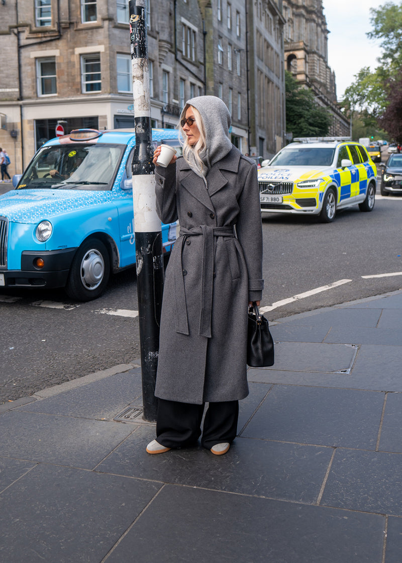 Classic, double-breasted wool coat in grey with collar and notch lapels. ShayMD coat has a wide tiebelt at waist, shoulder straps, wide cuffs and open yoke. With lining and single back vent.