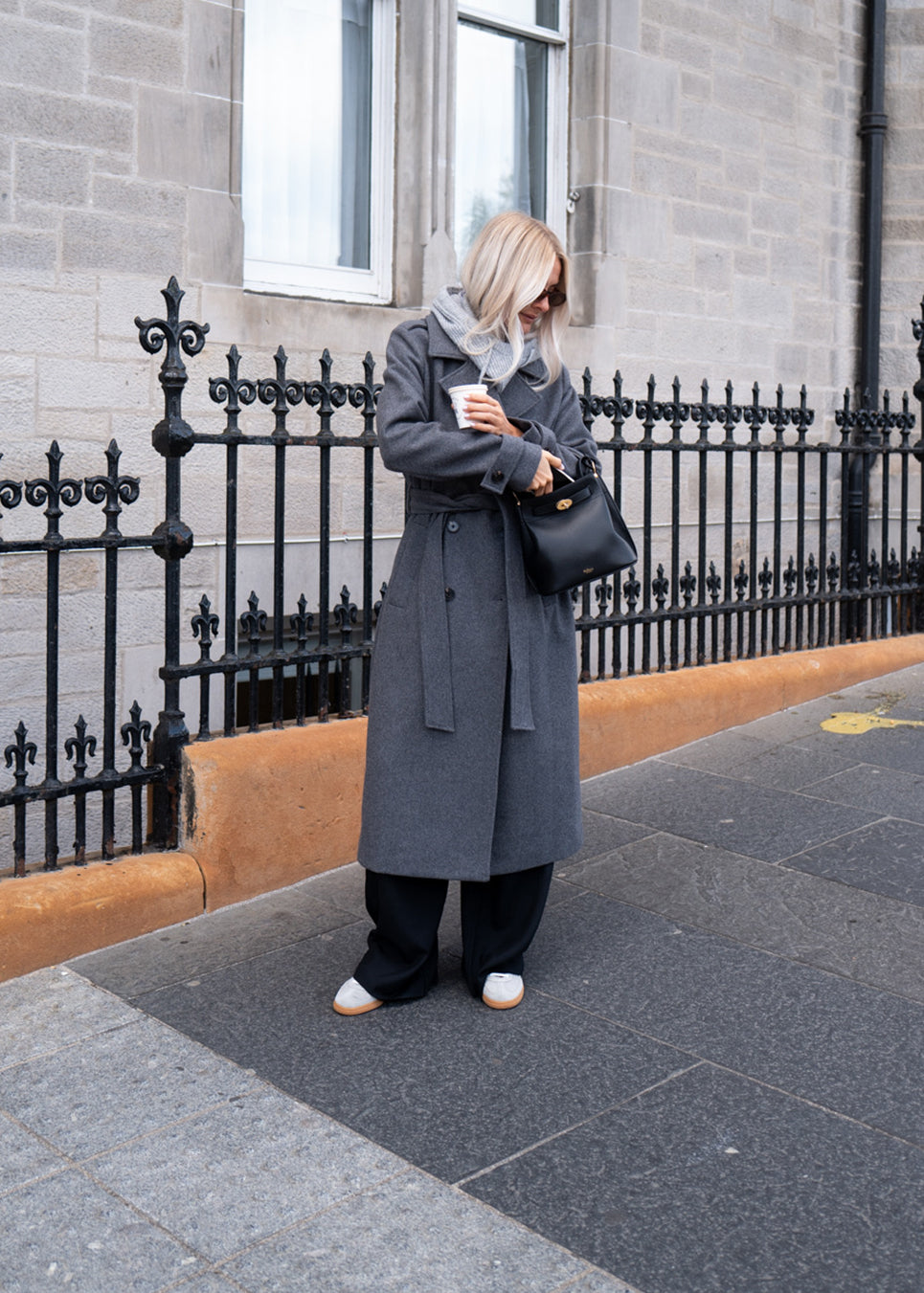 Classic, double-breasted wool coat in grey with collar and notch lapels. ShayMD coat has a wide tiebelt at waist, shoulder straps, wide cuffs and open yoke. With lining and single back vent.