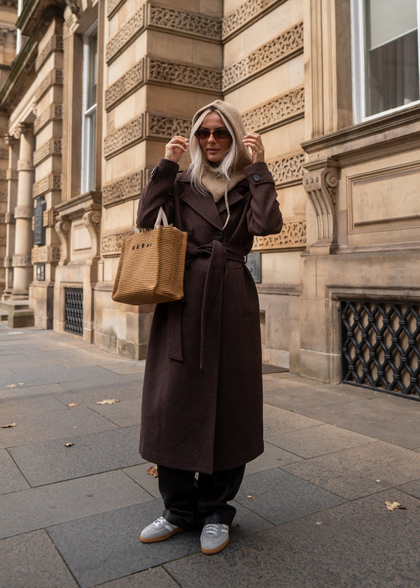 Classic, double-breasted wool coat with collar and notch lapels. ShayMD coat, in the color&nbsp;Dark Coffee, has a wide tiebelt at waist, shoulder straps, wide cuffs and open yoke. With lining and single back vent.