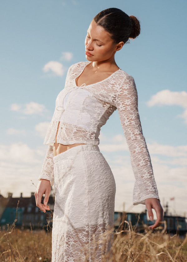 Maxi skirt in a white see-through lace material. TildeMD skirt has lining and an elastic waistband.<br>