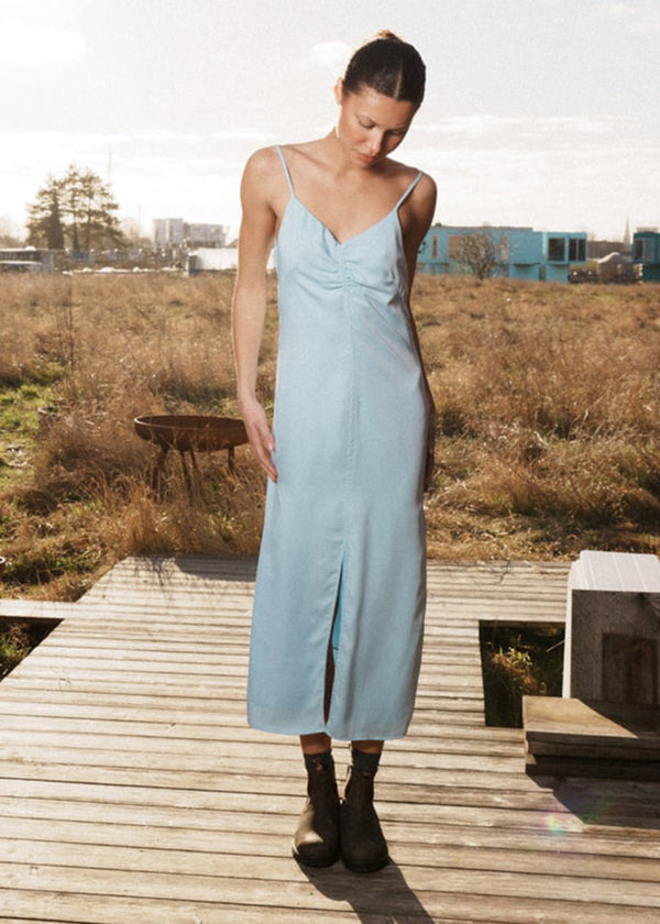 Maxi dress in baby blue with thin straps and an elastic gathering at the chest. TrentonMD print dress has a slit in the front and an invisible zipper at the back.