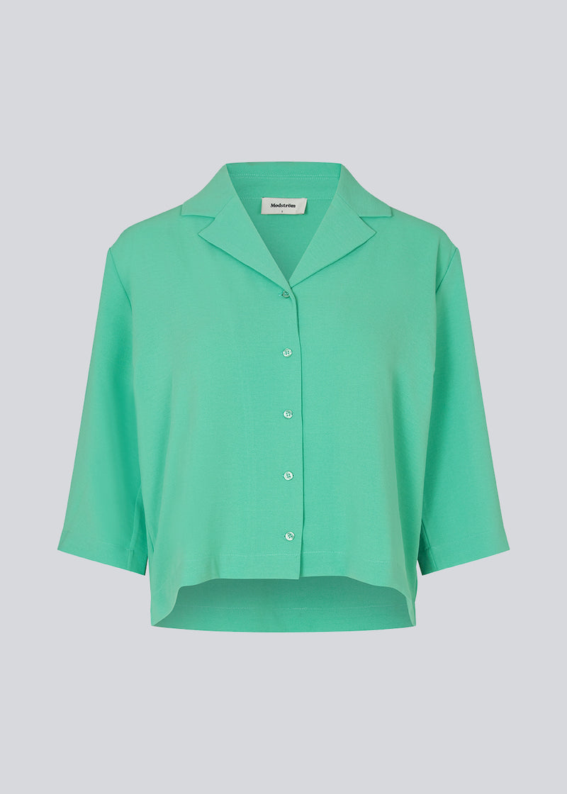 Shirt in green in a relaxed silhouette and 3/4 length sleeves. AaliyahMD shirt has a resort collar, dropped shoulders and button closure in front.