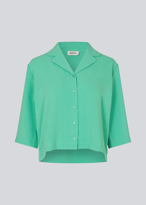 Shirt in green in a relaxed silhouette and 3/4 length sleeves. AaliyahMD shirt has a resort collar, dropped shoulders and button closure in front.