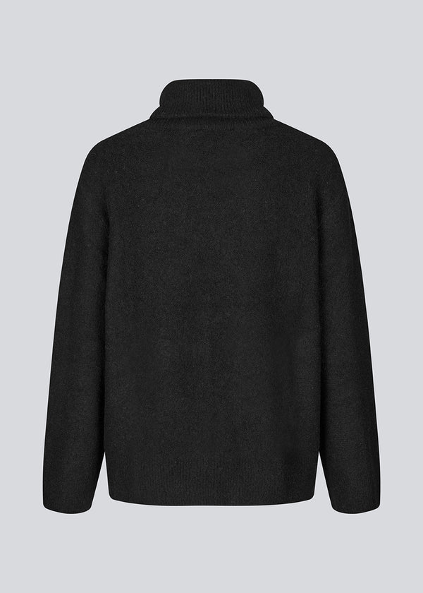 Black knitted jumper in wool and llama wool mix. AdrianMD t-neck has a relaxed fit with dropped shoulder, rib-knitted rollneck and trimmings.