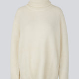 Oversized knitted jumper in white in wool and llama wool mix. AdrianMD t-neck has a relaxed fit with dropped shoulder, rib-knitted rollneck and trimmings. The model is 177 cm and wears a size S/36.