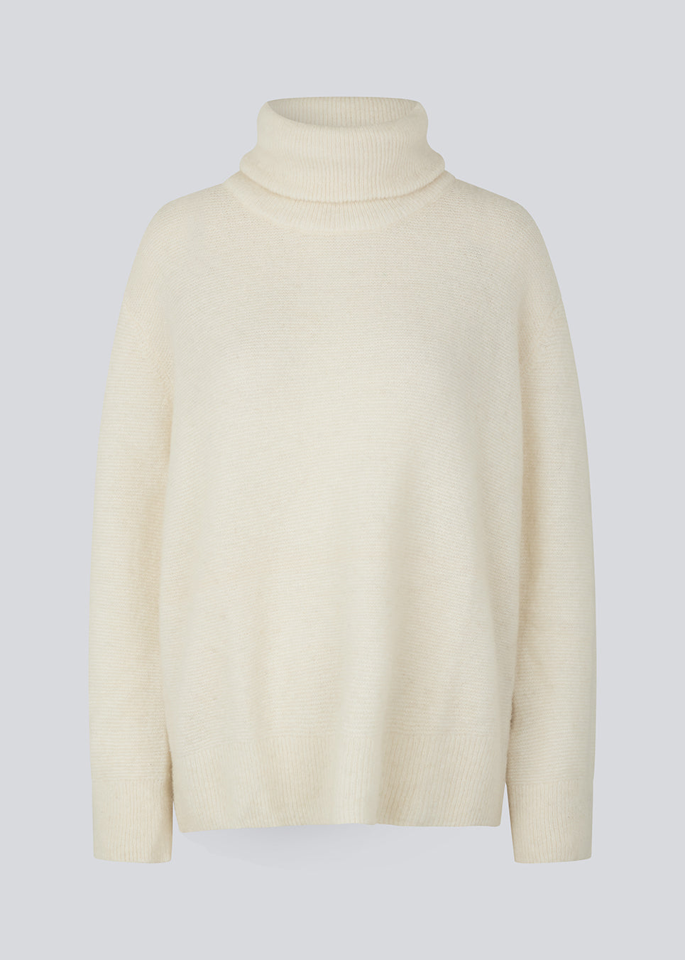 Oversized knitted jumper in white in wool and llama wool mix. AdrianMD t-neck has a relaxed fit with dropped shoulder, rib-knitted rollneck and trimmings. The model is 177 cm and wears a size S/36.