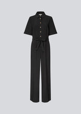 Shirt-inspired jumpsuit with a waist belt. The AgneteMD Jumpsuit features details such as a collar, button closure, short wide sleeves, straight legs, and pressed creases. A modern choice that combines comfort with style.