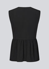 Feminine vest top with a gathered, loose hem. The AgneteMD Vest is sleeveless with a V-neckline and a simple button closure. Can be styled alone or layered for a modern and versatile look.