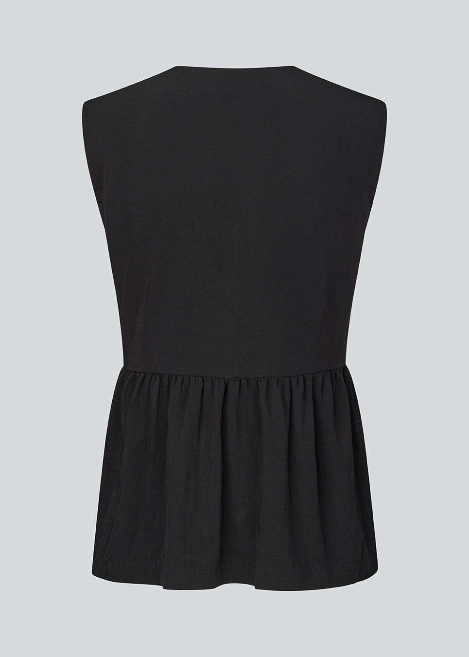 Feminine vest top with a gathered, loose hem. The AgneteMD Vest is sleeveless with a V-neckline and a simple button closure. Can be styled alone or layered for a modern and versatile look.
