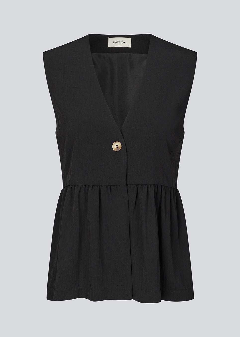 Feminine vest top with a gathered, loose hem. The AgneteMD Vest is sleeveless with a V-neckline and a simple button closure. Can be styled alone or layered for a modern and versatile look.
