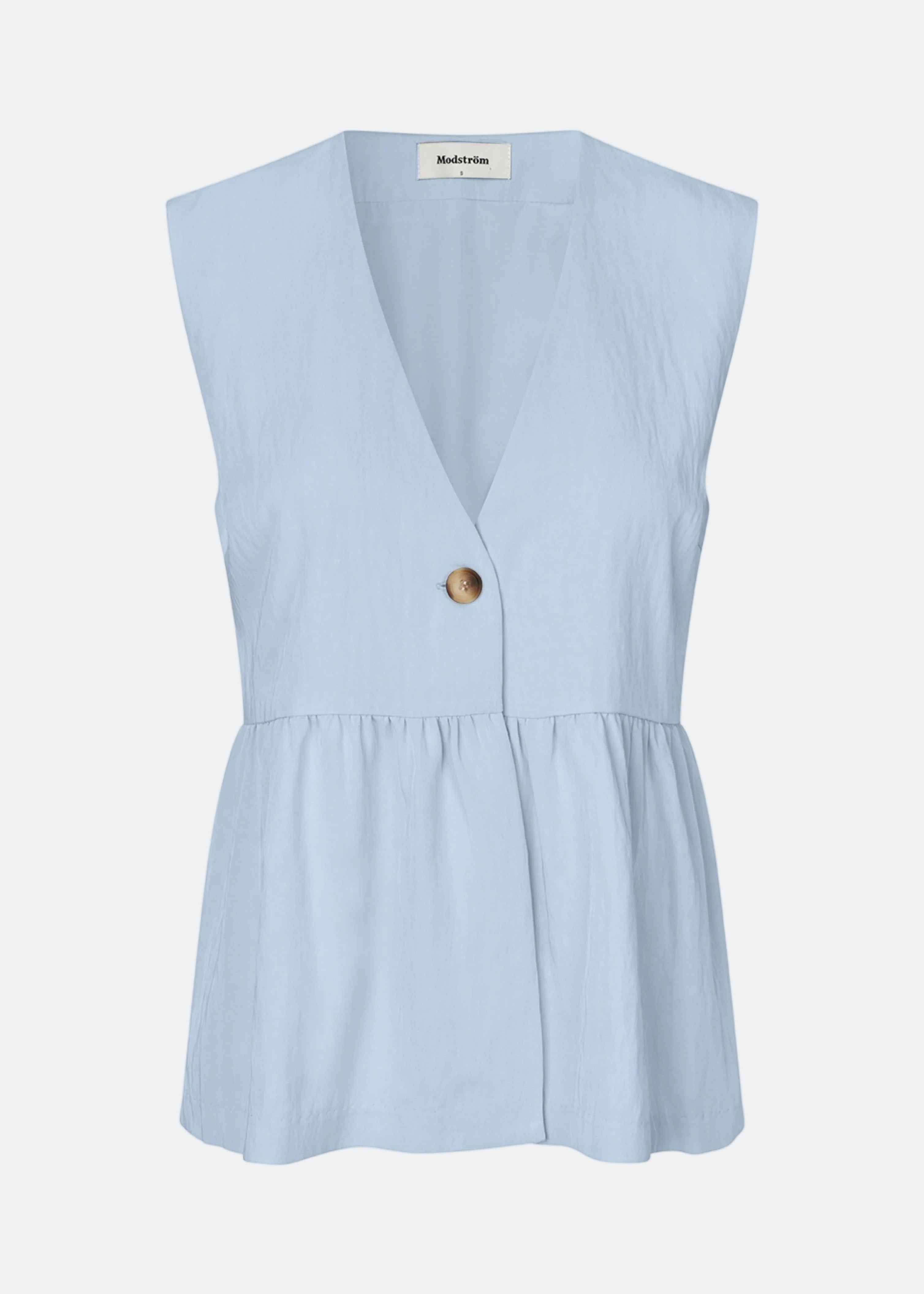 Feminine vest top with a gathered, loose hem. The AgneteMD Vest is sleeveless with a V-neckline and a simple button closure. Can be styled alone or layered for a modern and versatile look.