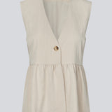 Feminine vest top with a gathered, loose hem. The AgneteMD Vest is sleeveless with a V-neckline and a simple button closure. Can be styled alone or layered for a modern and versatile look.