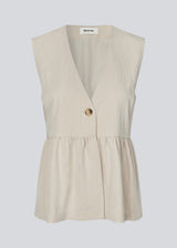 Feminine vest top with a gathered, loose hem. The AgneteMD Vest is sleeveless with a V-neckline and a simple button closure. Can be styled alone or layered for a modern and versatile look.