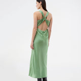 Long dress in lustrous satin with an open back. The AijaMD Dress features a feminine design with a beautifully draped skirt, a fitted waist, draping at the bust, and an elegant crisscross back. Made from 100% recycled polyester, it’s perfect for both evening and party looks.