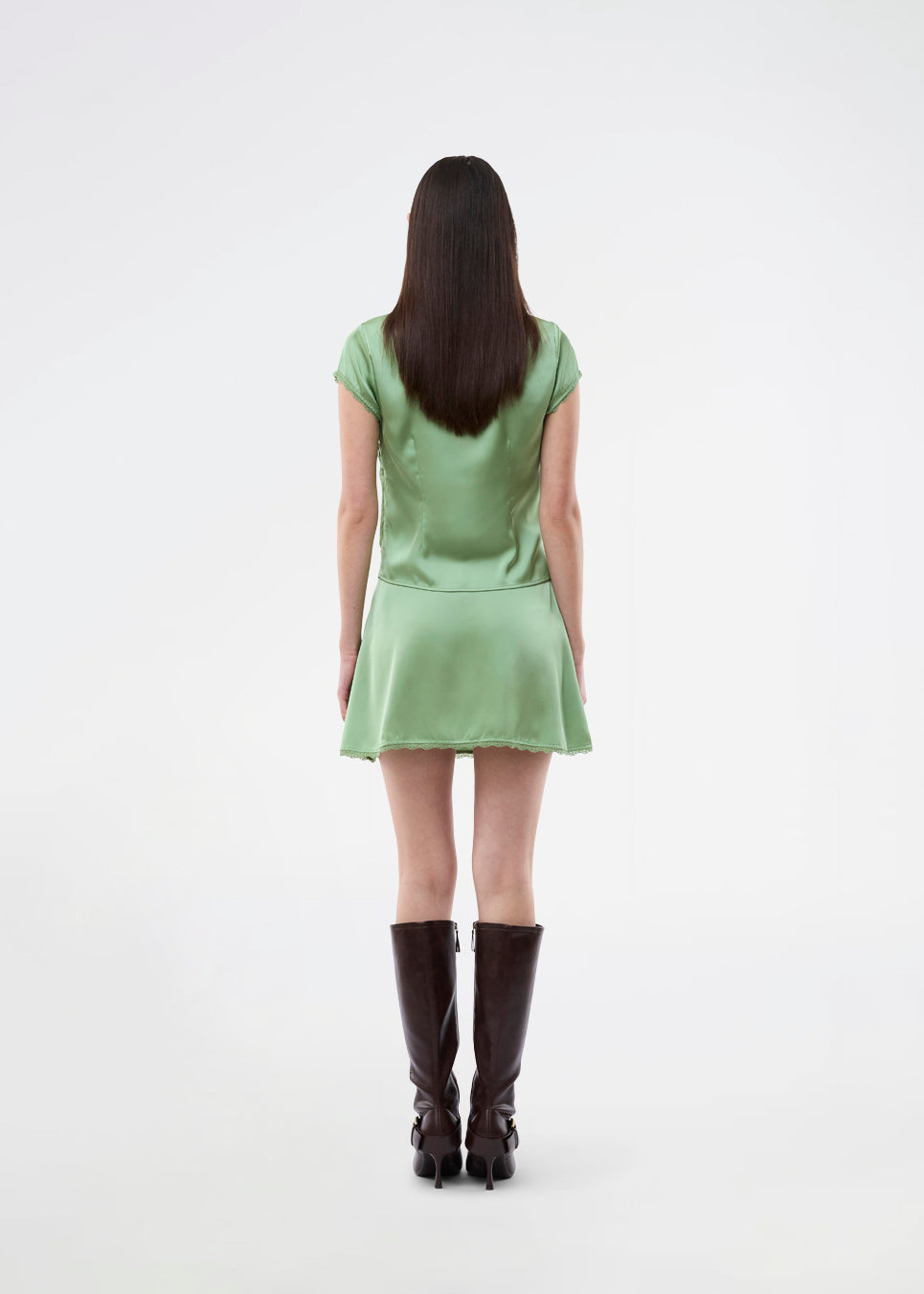 Mini skirt in lustrous satin. The AijaMD Skirt features feminine details such as a lace trim at the hem and a fitted cut that gently flares out at the bottom. The skirt has a discreet side zipper and is made from 100% recycled polyester.