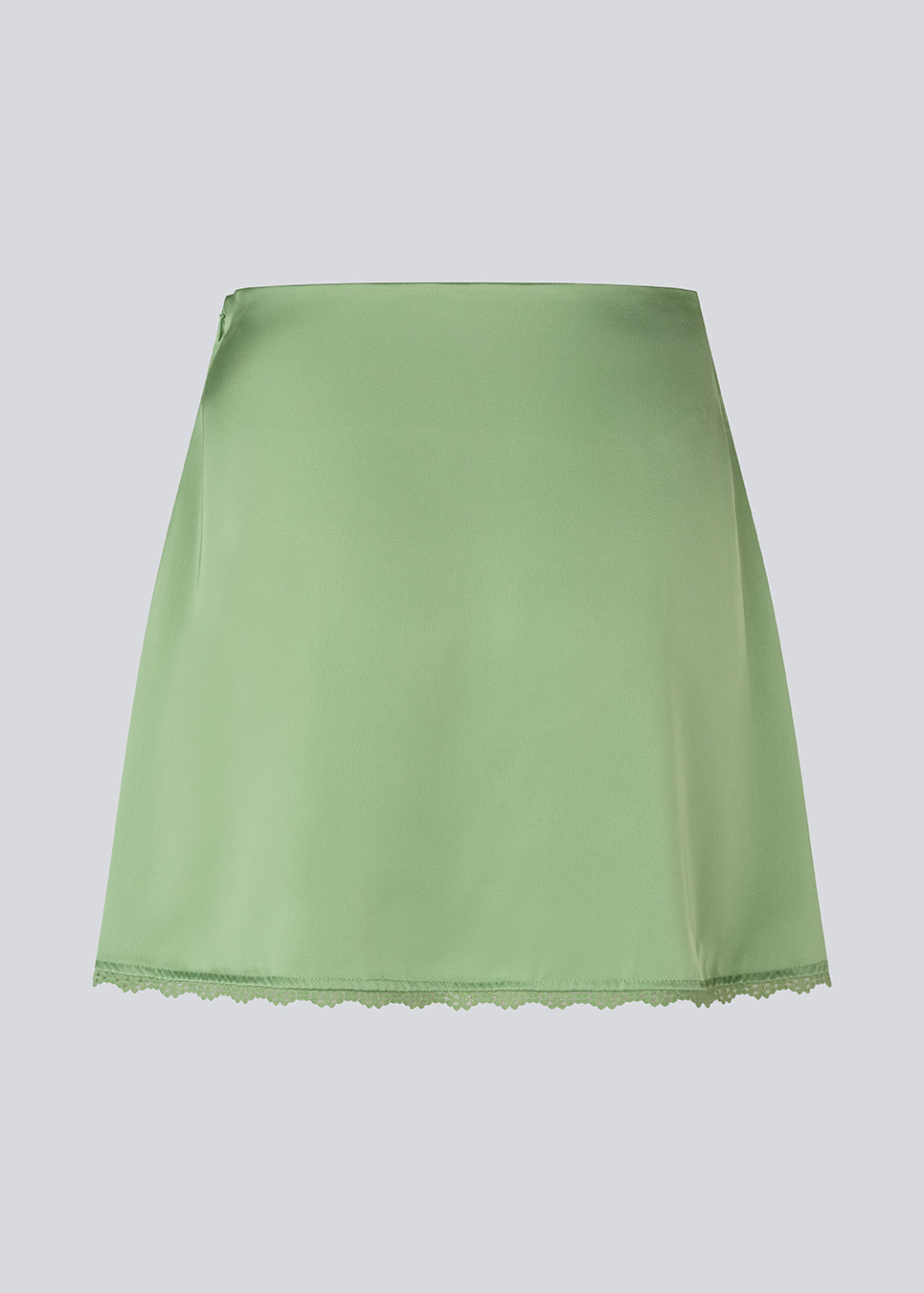 Mini skirt in lustrous satin. The AijaMD Skirt features feminine details such as a lace trim at the hem and a fitted cut that gently flares out at the bottom. The skirt has a discreet side zipper and is made from 100% recycled polyester.