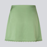 Mini skirt in lustrous satin. The AijaMD Skirt features feminine details such as a lace trim at the hem and a fitted cut that gently flares out at the bottom. The skirt has a discreet side zipper and is made from 100% recycled polyester.