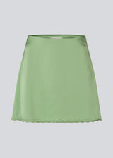 Mini skirt in lustrous satin. The AijaMD Skirt features feminine details such as a lace trim at the hem and a fitted cut that gently flares out at the bottom. The skirt has a discreet side zipper and is made from 100% recycled polyester.