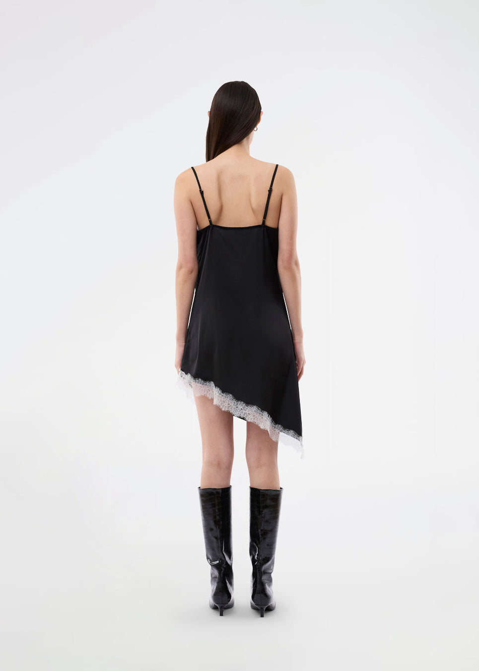 Short satin slip dress with contrast lace trim. The AlinkaMD Dress features spaghetti straps, a V-neckline, and an asymmetrical hem that is longer on one side. An elegant dress, perfect on its own or for layered styling.