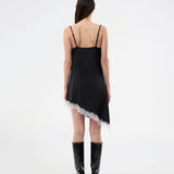 Short satin slip dress with contrast lace trim. The AlinkaMD Dress features spaghetti straps, a V-neckline, and an asymmetrical hem that is longer on one side. An elegant dress, perfect on its own or for layered styling.
