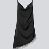 Short satin slip dress with contrast lace trim. The AlinkaMD Dress features spaghetti straps, a V-neckline, and an asymmetrical hem that is longer on one side. An elegant dress, perfect on its own or for layered styling.
