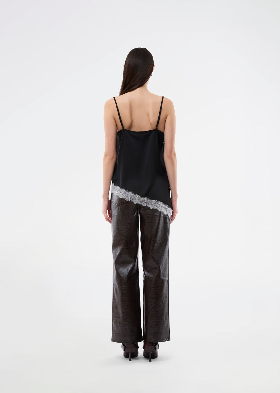 Satin slip top with contrast lace trim. The AlinkaMD Top features spaghetti straps, a V-neckline, and an asymmetrical hem that is longer on one side. An elegant top, perfect on its own or for layered styling.