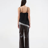 Satin slip top with contrast lace trim. The AlinkaMD Top features spaghetti straps, a V-neckline, and an asymmetrical hem that is longer on one side. An elegant top, perfect on its own or for layered styling.