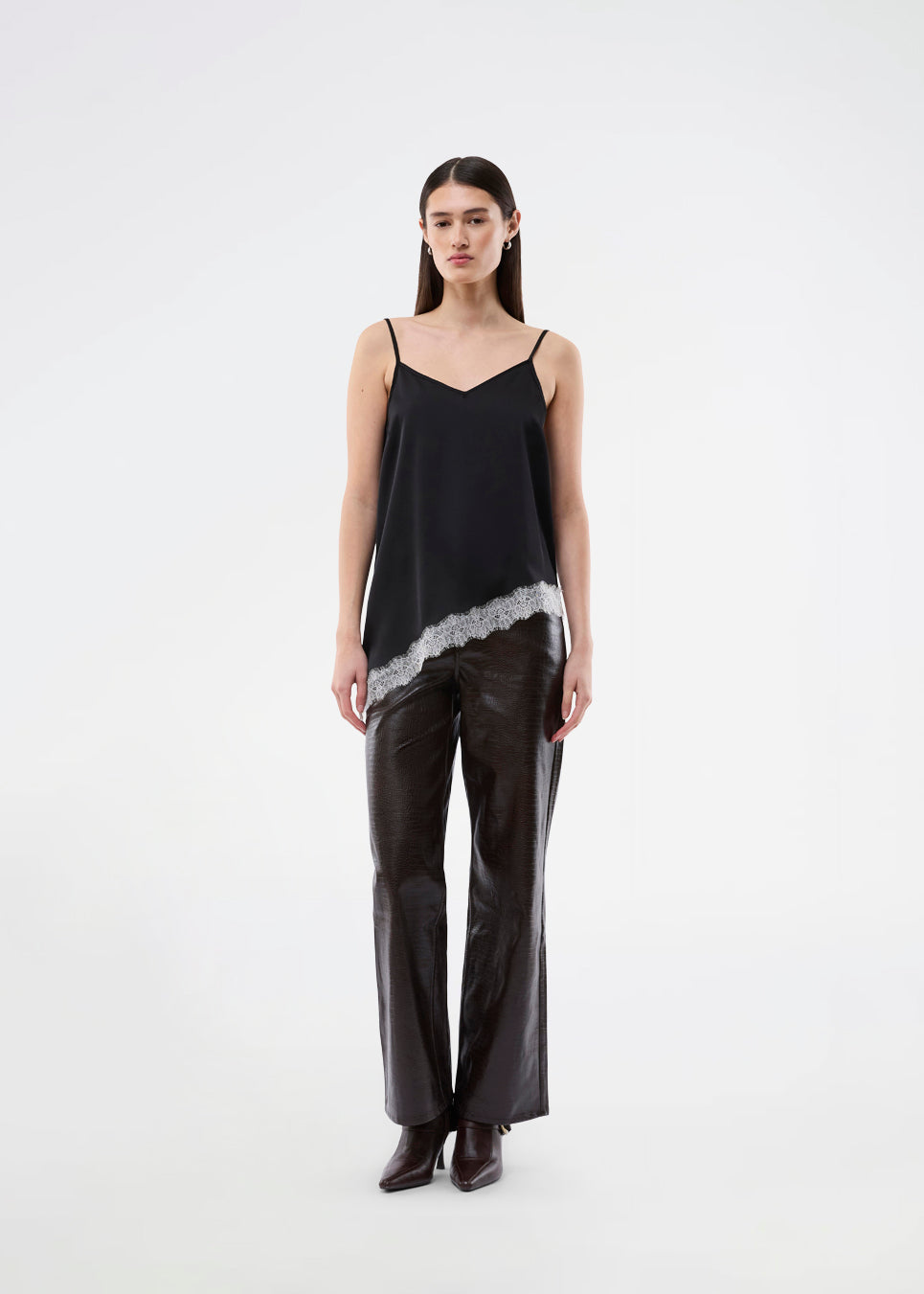 Satin slip top with contrast lace trim. The AlinkaMD Top features spaghetti straps, a V-neckline, and an asymmetrical hem that is longer on one side. An elegant top, perfect on its own or for layered styling.