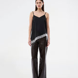 Satin slip top with contrast lace trim. The AlinkaMD Top features spaghetti straps, a V-neckline, and an asymmetrical hem that is longer on one side. An elegant top, perfect on its own or for layered styling.