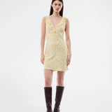 Feminine mini dress with a summery floral print. The AlyssaMD Print Dress is sleeveless and features a V-neckline with a ruffle trim and bow detail. The dress is fitted at the waist and has a beautifully flowing skirt, creating a feminine and elegant look.