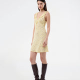 Feminine mini dress with a summery floral print. The AlyssaMD Print Dress is sleeveless and features a V-neckline with a ruffle trim and bow detail. The dress is fitted at the waist and has a beautifully flowing skirt, creating a feminine and elegant look.