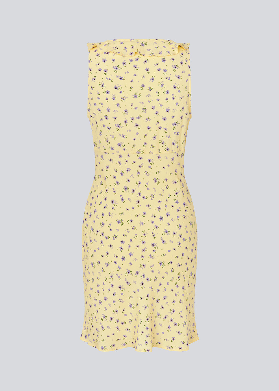 Feminine mini dress with a summery floral print. The AlyssaMD Print Dress is sleeveless and features a V-neckline with a ruffle trim and bow detail. The dress is fitted at the waist and has a beautifully flowing skirt, creating a feminine and elegant look.