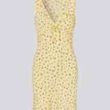 Feminine mini dress with a summery floral print. The AlyssaMD Print Dress is sleeveless and features a V-neckline with a ruffle trim and bow detail. The dress is fitted at the waist and has a beautifully flowing skirt, creating a feminine and elegant look.