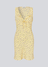 Feminine mini dress with a summery floral print. The AlyssaMD Print Dress is sleeveless and features a V-neckline with a ruffle trim and bow detail. The dress is fitted at the waist and has a beautifully flowing skirt, creating a feminine and elegant look.