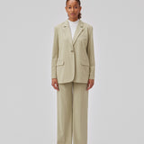 Oversized blazer in spray green with a drapy fit. AnkerMD blazer has collar and notch lapels with a single button closure. Flap welt front pockets. Slits on cuffs and single back vent. Lined.  Shop matching pants: AnkerMD pants.