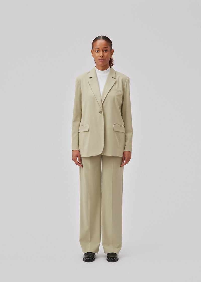 Oversized blazer in spray green with a drapy fit. AnkerMD blazer has collar and notch lapels with a single button closure. Flap welt front pockets. Slits on cuffs and single back vent. Lined.  Shop matching pants: AnkerMD pants.