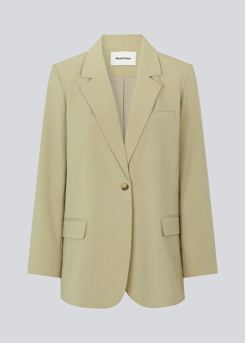Oversized blazer in spray green with a drapy fit. AnkerMD blazer has collar and notch lapels with a single button closure. Flap welt front pockets. Slits on cuffs and single back vent. Lined.  Shop matching pants: AnkerMD pants.