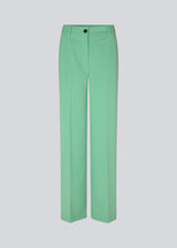 Pants in green with wide legs and a medium waist. AnkerMD pants have creases, button and zip fly, side pockets, and paspel back pockets. The model is 177 cm and wears a size S/36. Style the pants with a matching blazer in the same color: AnkerMD blazer.