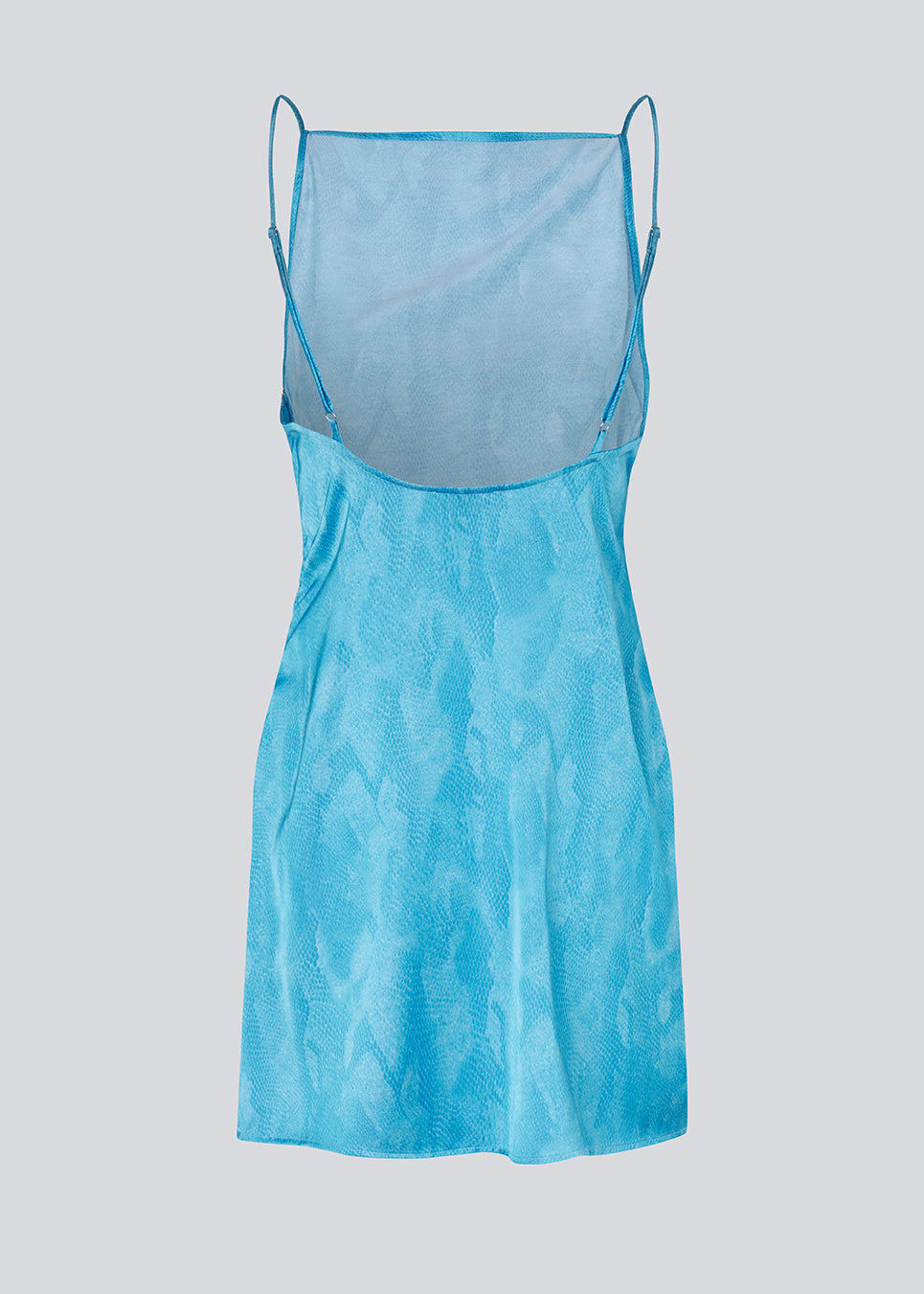 Mini dress in glossy snake print. The AunaMD Print Dress features adjustable spaghetti straps, a deep back, side ruching, and a straight cut across the bust. A modern and feminine dress, perfect for festive and summery looks.