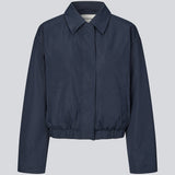 Modern and functional jacket. The Badumd jacket is designed with a classic collar, concealed fastening, and an elasticated hem that creates a relaxed, slightly cropped silhouette. A stylish transitional jacket that combines a minimalist look with comfort and versatile styling options.