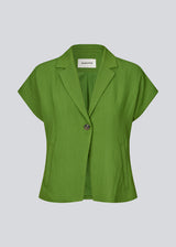 Short-sleeved blazer vest with a notched collar. The BenittaMD Vest features a relaxed, waist-focused fit, side pockets, and a single-button closure – the lightweight fabric creates a modern, effortless look, perfect worn alone or layered for a sharp, fashion-forward style.
 