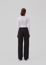 High-waisted pants in black with pleats and long, wide legs. BennyMD pants has zip fly and button, belt loops, discreet side pockets, and decorative paspoil pockets on the back.