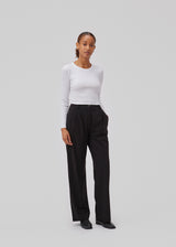 High-waisted pants in black with pleats and long, wide legs. BennyMD pants has zip fly and button, belt loops, discreet side pockets, and decorative paspoil pockets on the back.