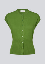 Feminine sleeveless cardigan in lightweight, luxurious knit. The Bernadette MD Vest features elegant ribbed trims, a stylish button closure, and a round neckline, with a tailored fit and an extra-wide ribbed waistband. Made from soft, 100% organic cotton – a timeless wardrobe must-have.