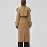 Coat in Dune in trenchcoat style with an oversized silhouette. BorakMD coat is double-breasted with a collar, open yoke, belt at the waist, and a slit in the back. Woolen quality. Lined.