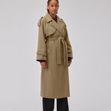 Coat in Dune in trenchcoat style with an oversized silhouette. BorakMD coat is double-breasted with a collar, open yoke, belt at the waist, and a slit in the back. Woolen quality. Lined.