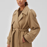 Coat in Dune in trenchcoat style with an oversized silhouette. BorakMD coat is double-breasted with a collar, open yoke, belt at the waist, and a slit in the back. Woolen quality. Lined.