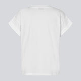 White t-shirt in organic cotton with a slightly cropped length. BrazilMD short t-shirt has a rounder neck and rolled-up sleeves. The model is 177 cm and wears a size S/36.
